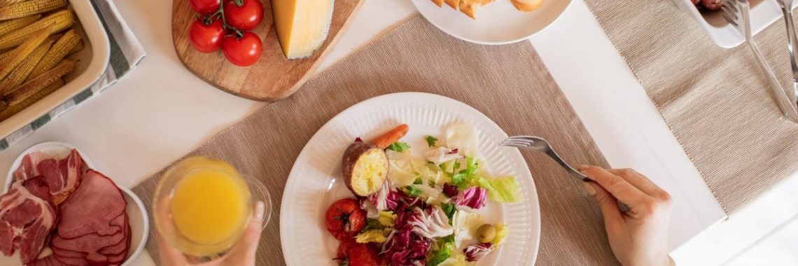 Top view of a delicious homemade meal with cheese, salad, and assorted ingredients.